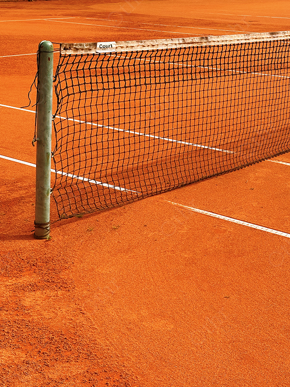 Clay Tennis Court With Net in Warm Light