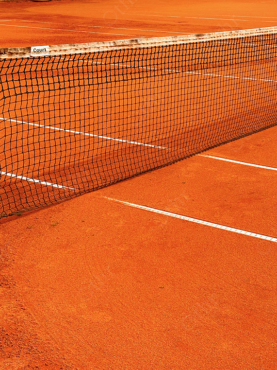 Tennis Net Casting Shadows Across a Clay Court