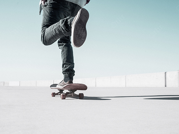 Low Angle View of a Skateboarder Pushing Forward on a Bright Outdoor Surface