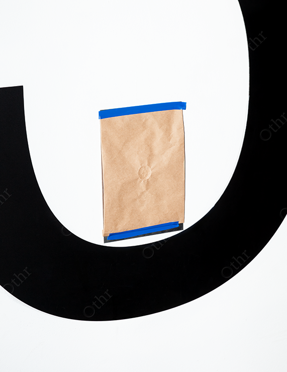 Brown Paper Sheet Taped to a Black and White Graphic Surface