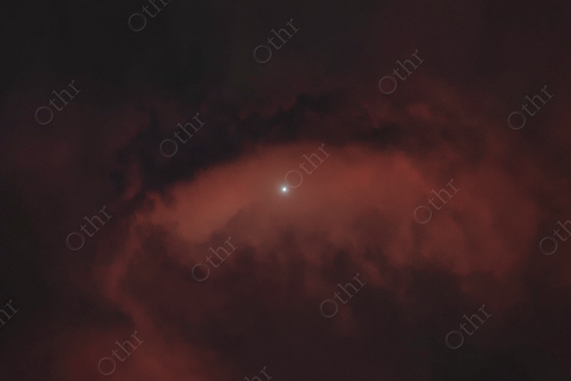 Bright Star Framed by Dark Red Storm Clouds at Night