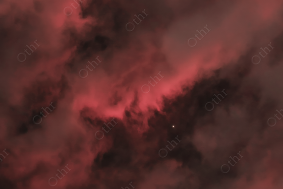 Star Revealed Through Dark Red Storm Clouds