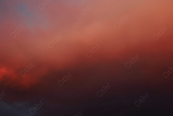 Soft Red and Dark Clouds Blending Across a Dusk Sky