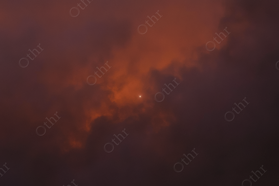 Single Star Shining Through Dark Red Storm Clouds