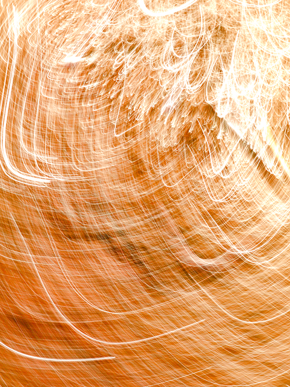 Abstract Light Trails Forming Swirling Golden Patterns