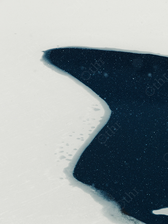 Dark Meltwater Opening in Snow-Covered Frozen Surface