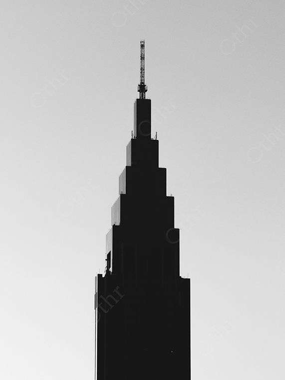 Silhouetted Skyscraper Tower Against a Clear Sky