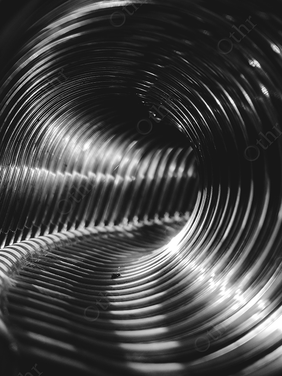 Curved Close-Up of Reflective Metal Coils in Monochrome