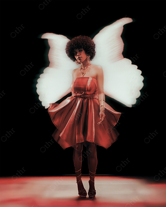 Woman in Red Dress With White Angel Wings Standing Under Spotlight Against Black Background
