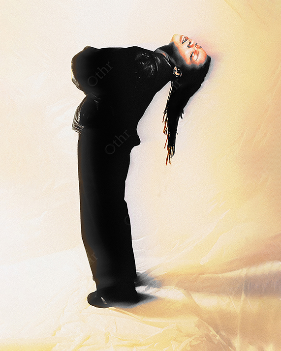 Woman Leaning Backward in Black Outfit Against Warm Gradient Background With Soft Motion Blur