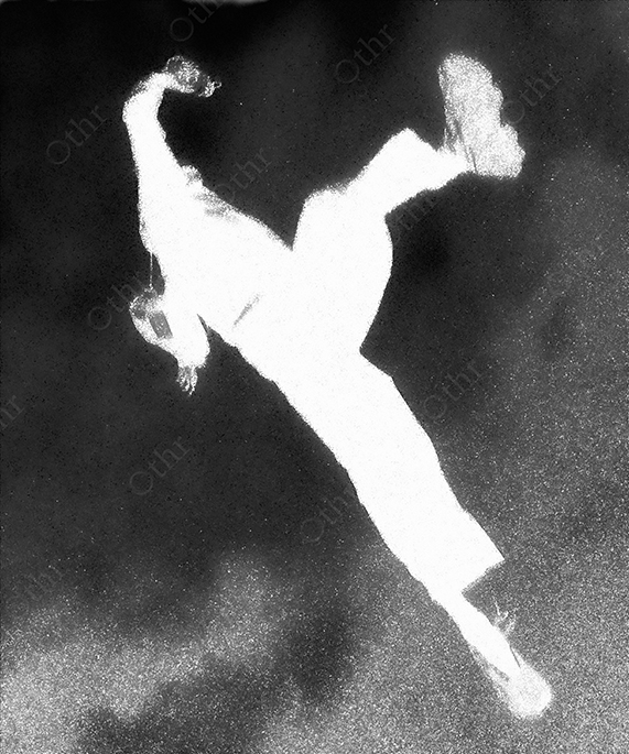 High-Contrast Silhouette of Person Frozen Mid-Air Against Grainy Dark Background in Black and White
