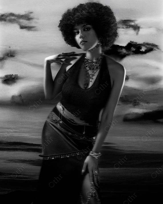 Black and White Portrait of Woman With Afro Hairstyle Posing in Fitted Outfit Against Clouded Sky