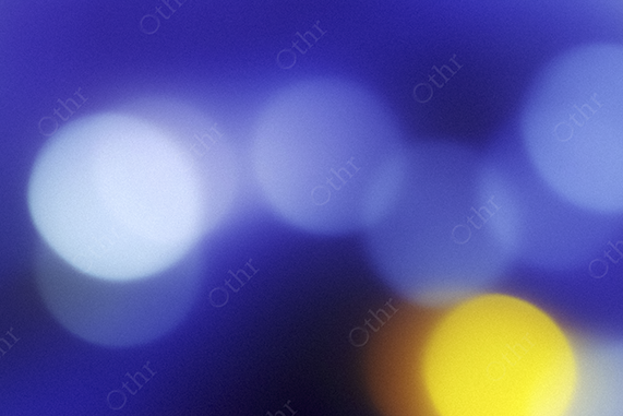 Soft Focus Bokeh Light Orbs With Yellow Accent on Blue Background