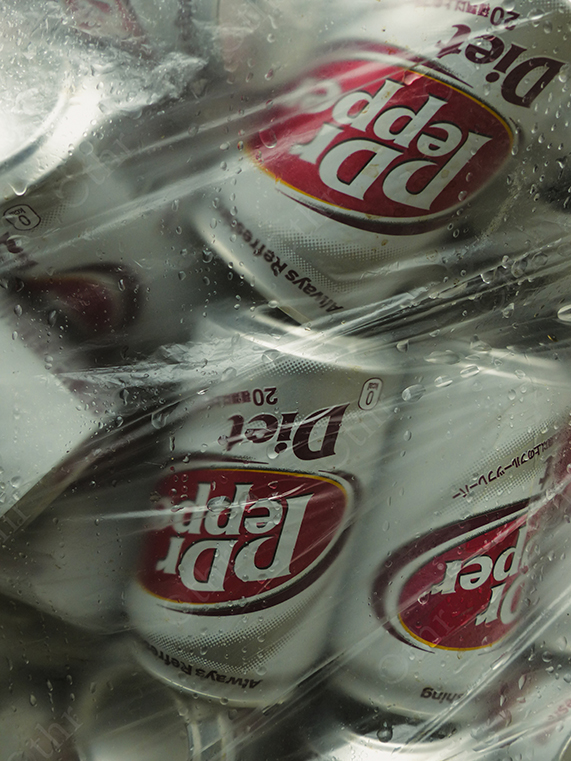 Crushed Diet Dr. Pepper Cans Wrapped in Wet Transparent Plastic