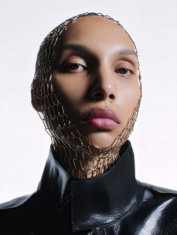 Studio Portrait of Person Wearing a High Neck Leather Top with Mesh Head Covering
