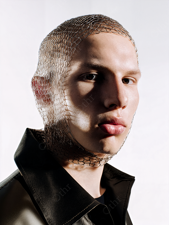Studio Portrait of Person with Mesh Head Covering