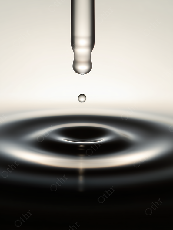 Droplet falling from pipette into liquid surface, creating ripple.