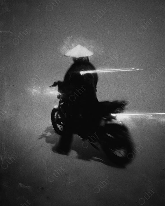 Dark samurai on motorcycle with sword in fog