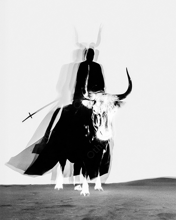 Black and red warrior with two spear riding a bull.
