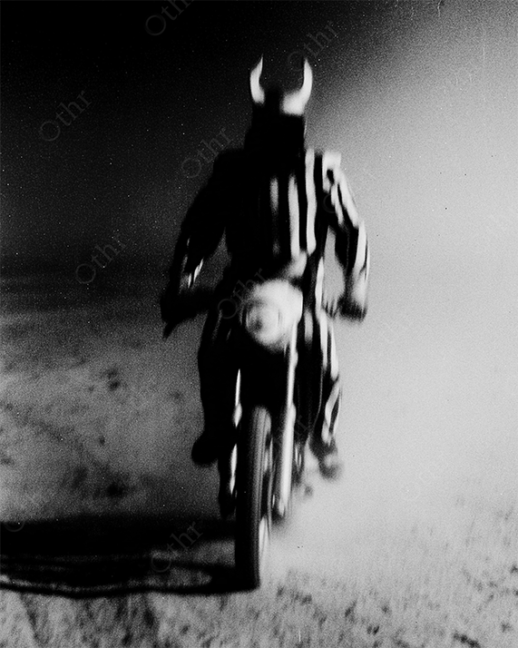 Blurred warrior riding toward camera in desert landscape