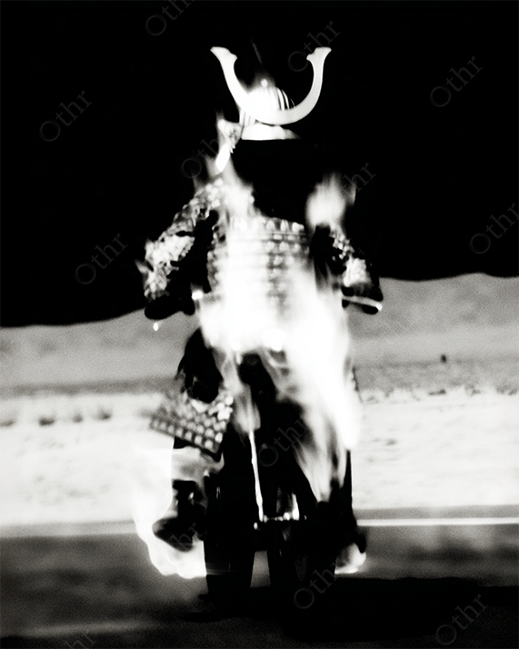 Glowing samurai in motion on black and white desert background