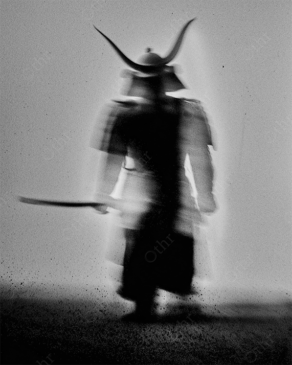 A samurai with sword glowing in the shadows