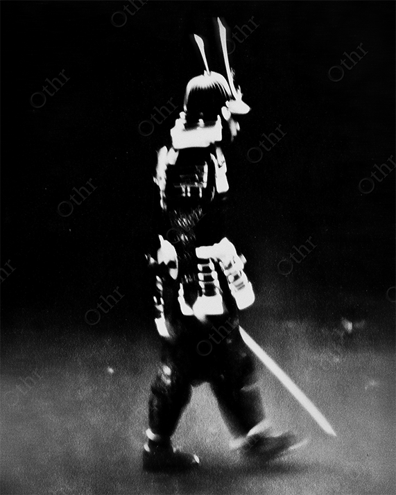 Profile view of samurai walking with a sword