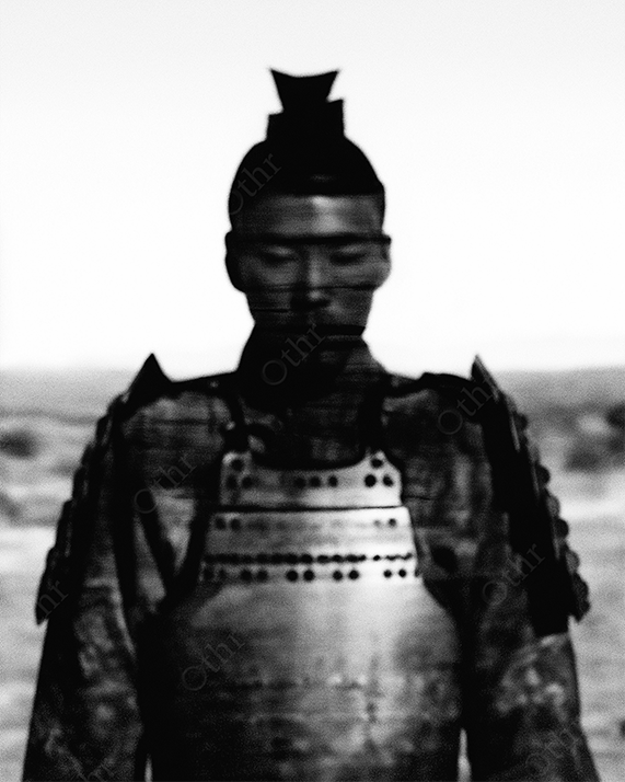 Portrait of stoic samurai in black and white.