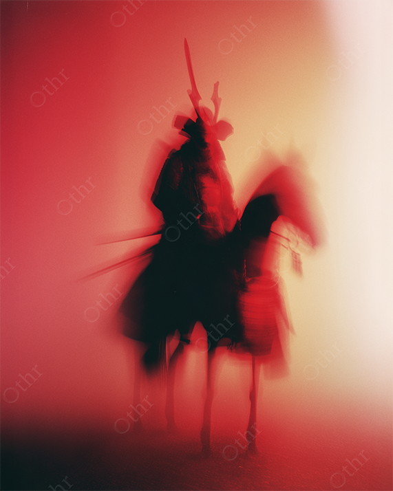 Blurred double exposure of a samurai on a horse in red monochrome