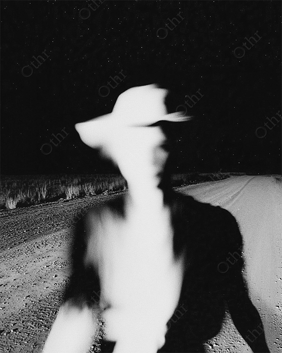 Blurred cowboy figure under night sky