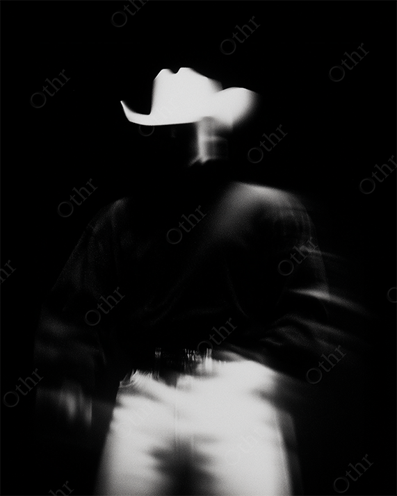 Blurry portrait of cowboy with hat and jacket