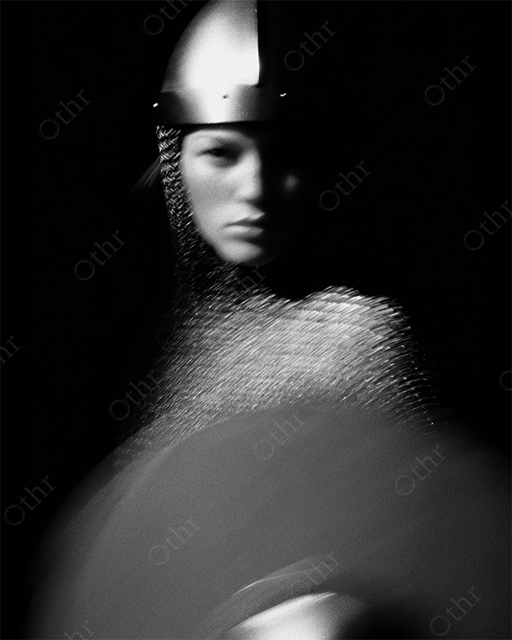Female knight in chainmail with downward gaze
