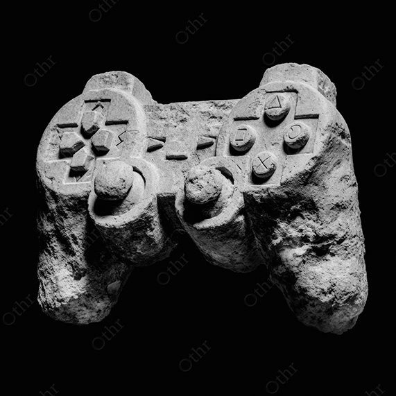 A white stone gaming controller on black background.