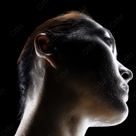 Dark, softly backlit portrait