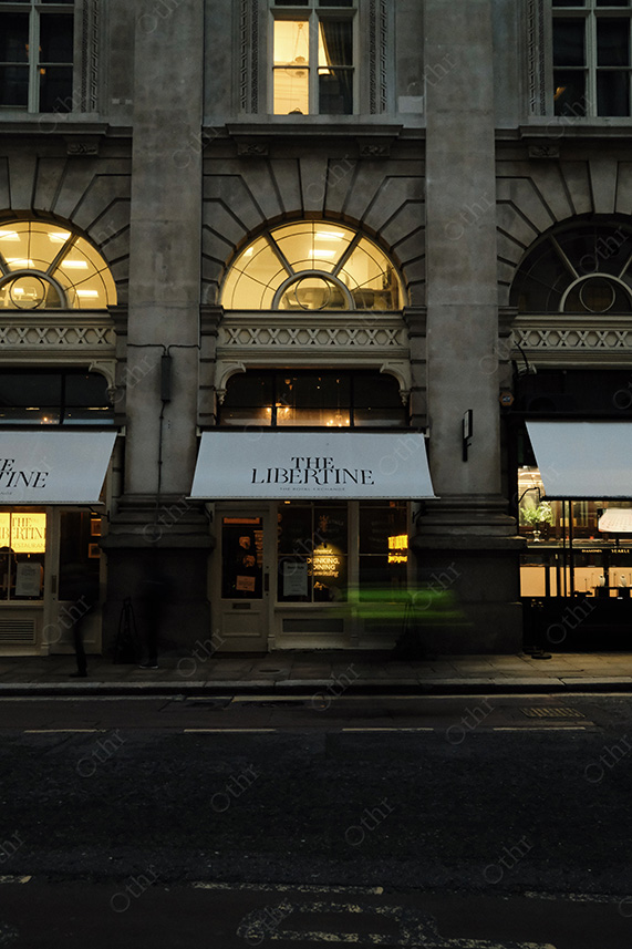 Stone Facade With Lit Arched Windows and Motion Blur on a Dark Street