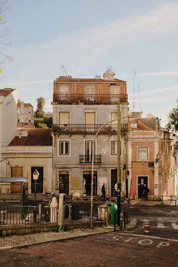 Tiled Building Facade With Balconies and Street Corner Details in Soft Daylight