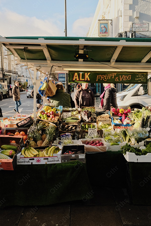 Street Market Fruit and Vegetable Stall With Shoppers in Bright Daylight