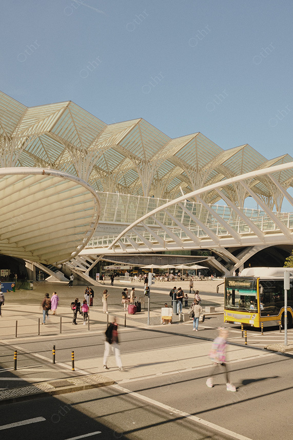 Busy City Square Beneath Contemporary Canopy With Pedestrians, Tram Lines, and Bus
