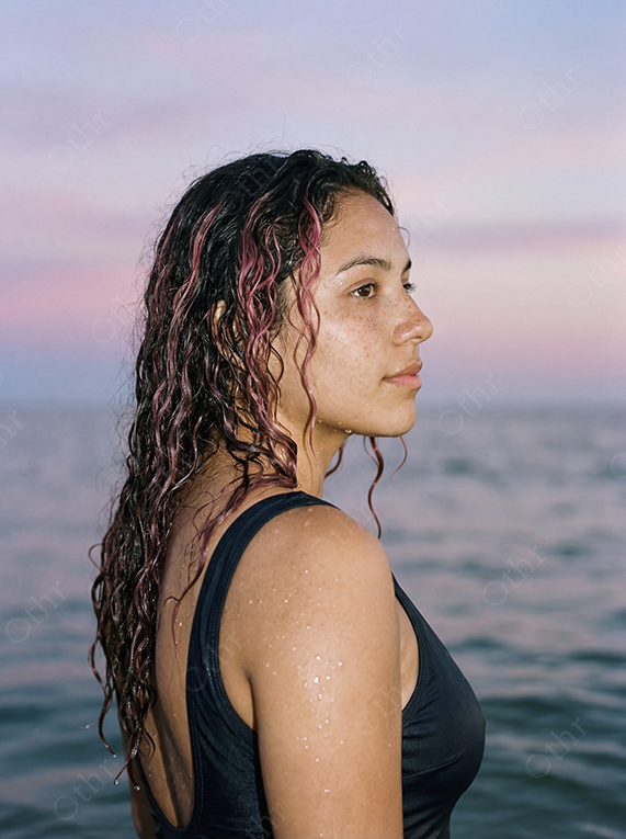 Side Profile Portrait of Woman With Wet Curly Hair in Ocean at Sunset