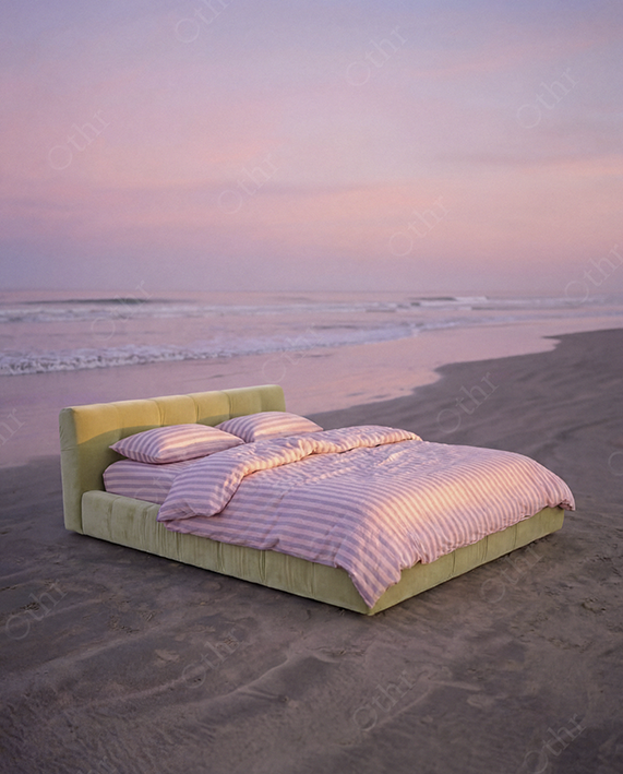 Minimal Bed With Pink Striped Bedding on Sandy Beach at Dusk