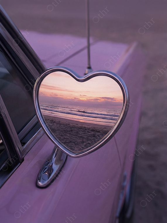 Heart-Shaped Car Side Mirror Reflecting Beach Sunset