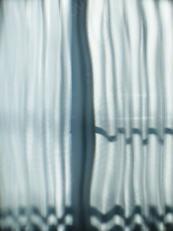 Abstract Vertical Light Distortion Through Frosted Glass with Soft Blue Tones