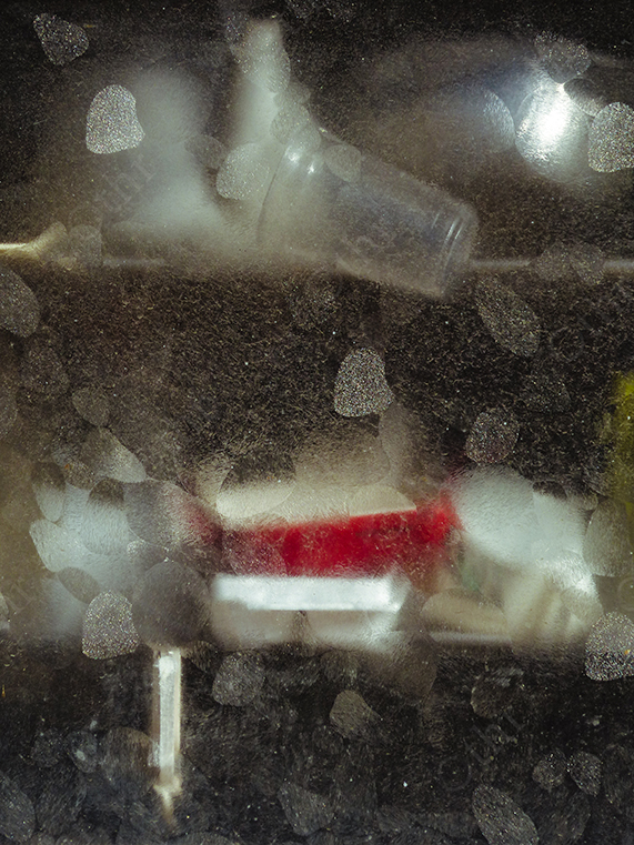 Dusty Glass Surface with Blurred Bottle and Soft Light Reflections Behind