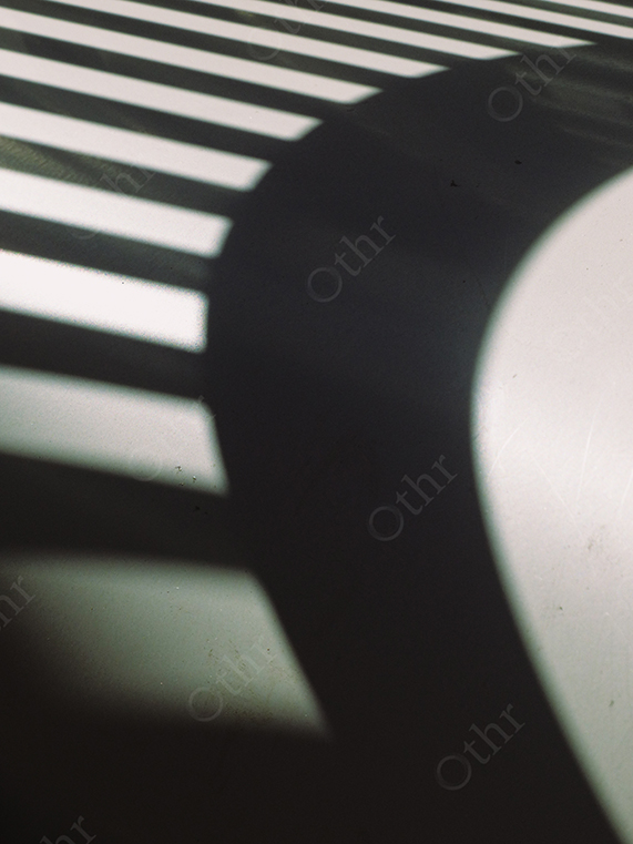 Strong Shadow Pattern of Railings Cast on Smooth Surface with High Contrast Light