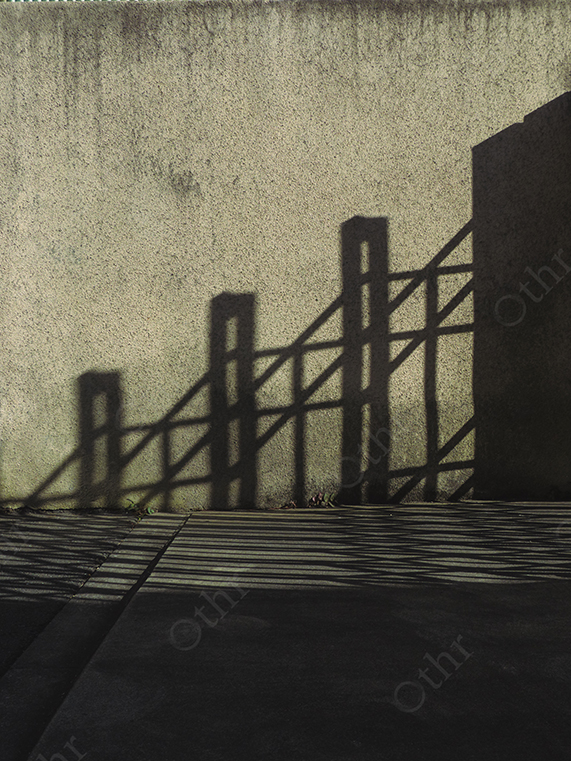 Geometric Shadow of Fence Cast on Concrete Wall with Strong Sunlight