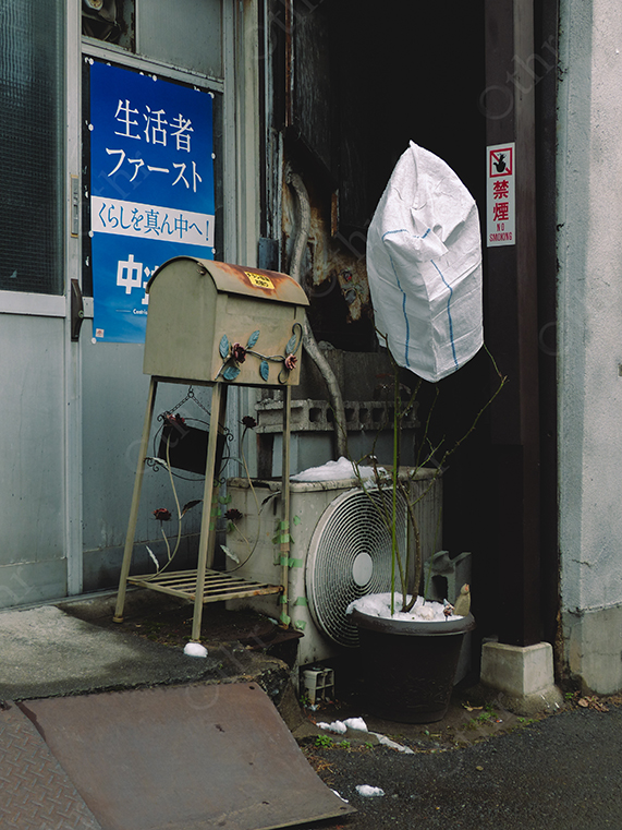 Urban Entrance with Mailbox, Air Conditioning Unit and Japanese Signage in Narrow Alley