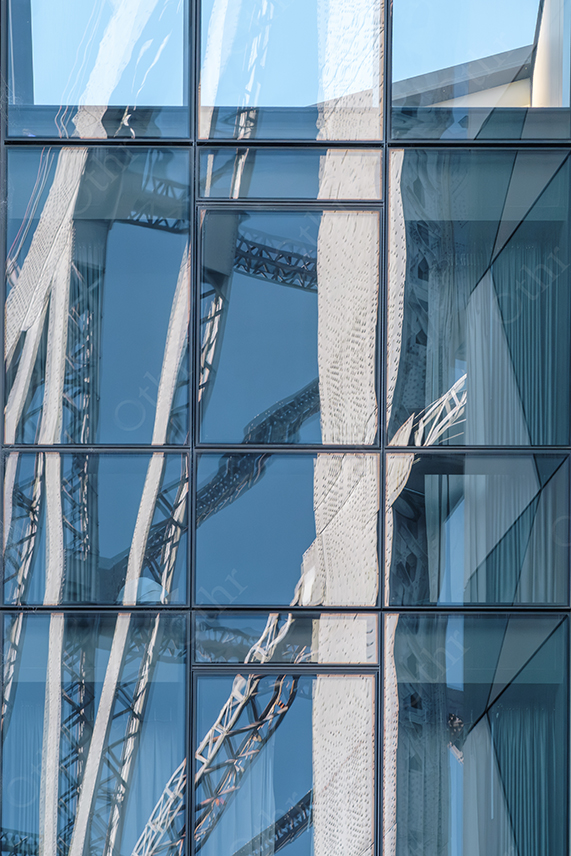 Modern Glass Building Reflecting Steel Structure With Geometric Window Pattern