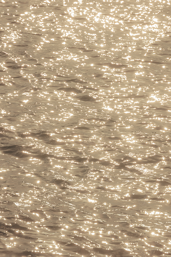 Sunlight Sparkling on Water Surface With Golden Reflections and Ripples